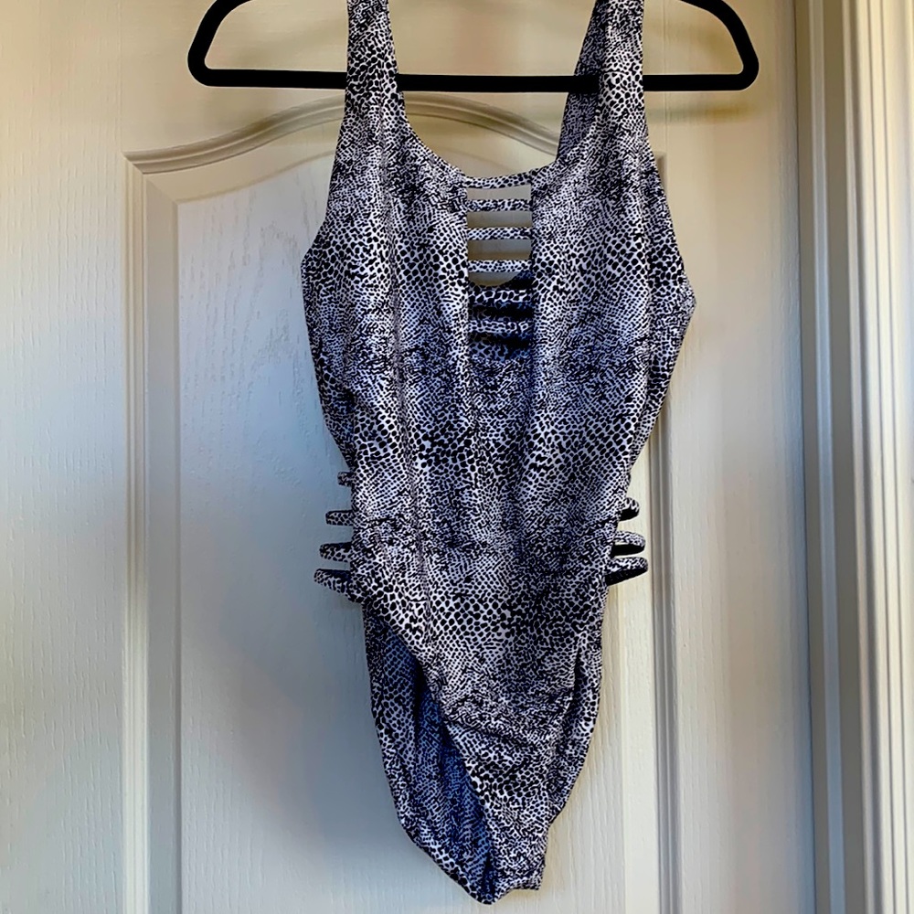 Never worn Volcom snake skin print one piece swim suit is a size L.